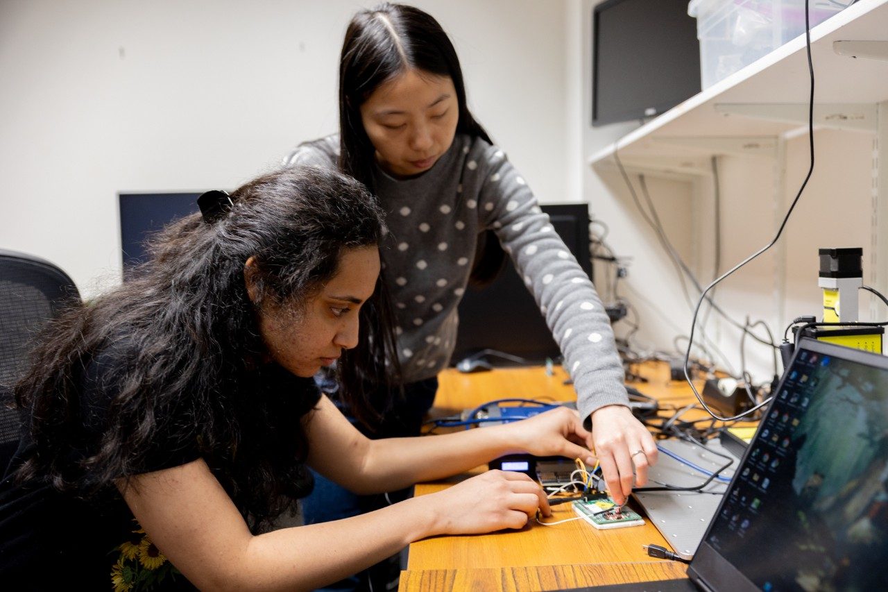 Wenjie Xiong (at right), assistant professor of electrical and computer engineering, works with a graduate student on high-performance hardware designs that don't skimp on security. Photo by Ben Murphy for Virginia Tech.